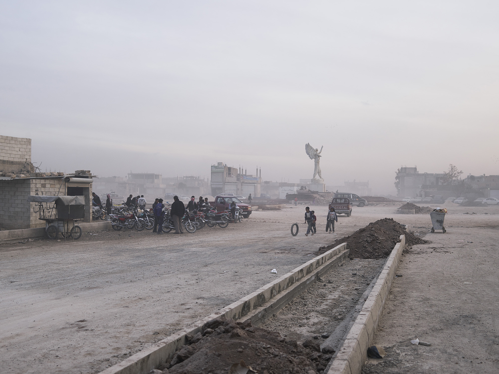 Joey L Kurdistan 002 ‘The Dusty Streets Of Kobane With YPJ Martyr Statue’
