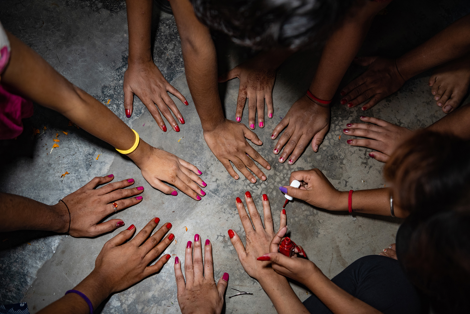 A group of women paint their nails, Bangladesh