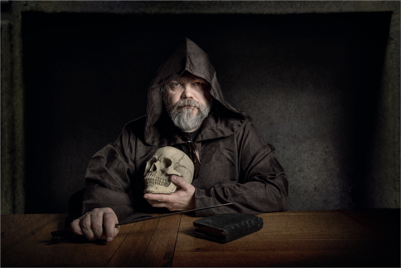 A self portrait Of Gary Hurdman dressed as a monk and holding a skull.