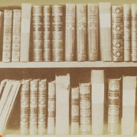 A salted paper print of a row of books in Fox Talbot's library