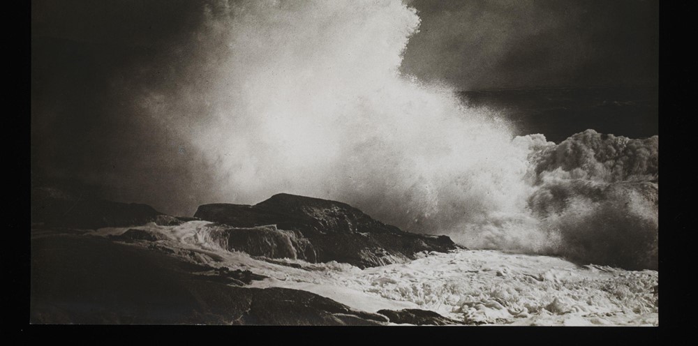 A photograph of waves crashing into the shore. 